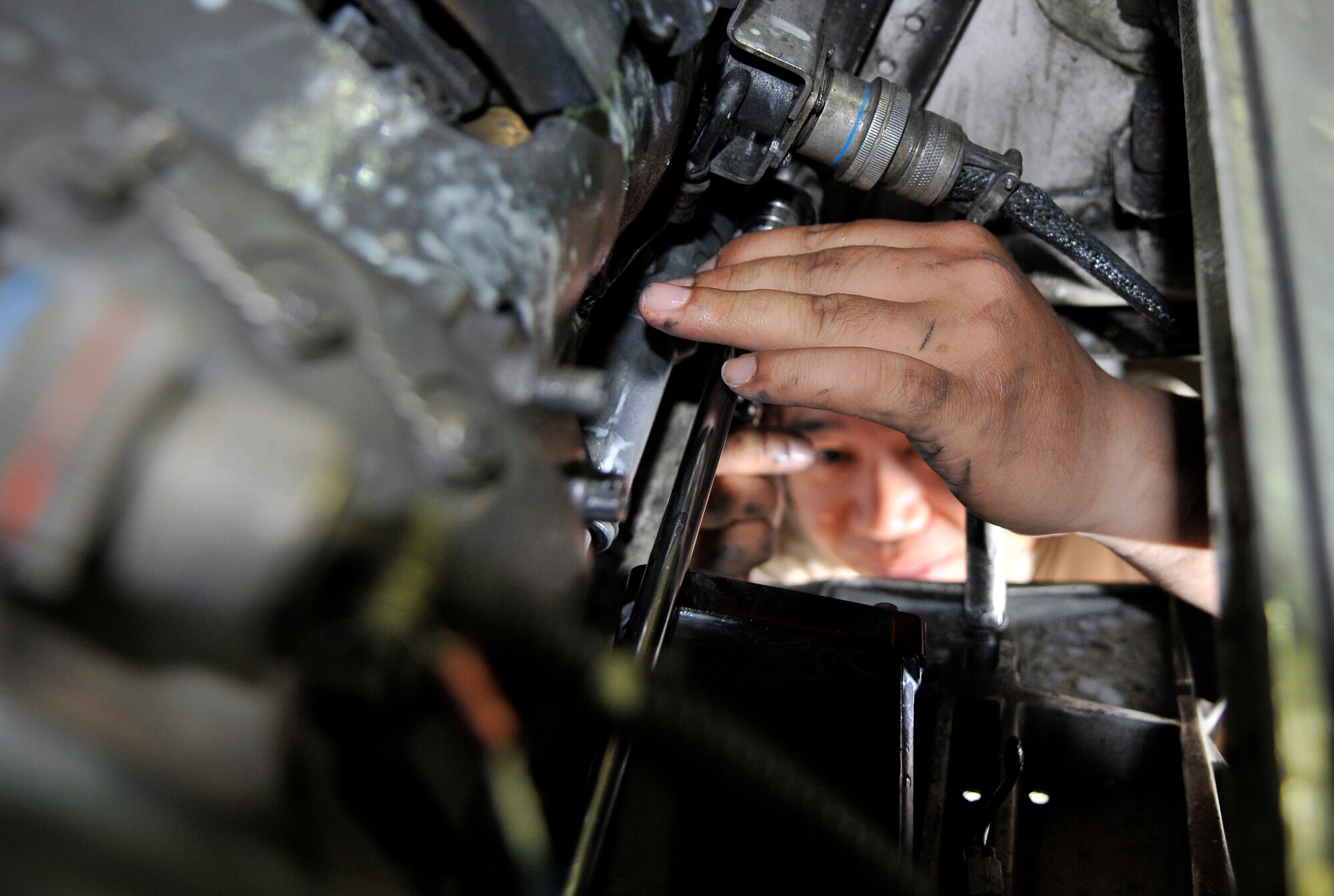 Staff Sgt. Sherwyn Mabute, 332nd Expeditionary Maintenance Squadron aircraft armament technician, disconnects a oil tube from a M-61A1 20mm multi-barrel cannon to replace a malfunctioning oiling unit on the F-16 Fighting Falcon Oct. 10, 2010, Joint Base Balad, Iraq. The oiling unit lubricates the cannon with each round fired ensuring proper operation. Sergeant Mabute is a native of Kodiak, Alaska, deployed from Misawa Air Base, Japan. (U.S. Air Force photo/Tech. Sgt. Phillip Butterfield)

