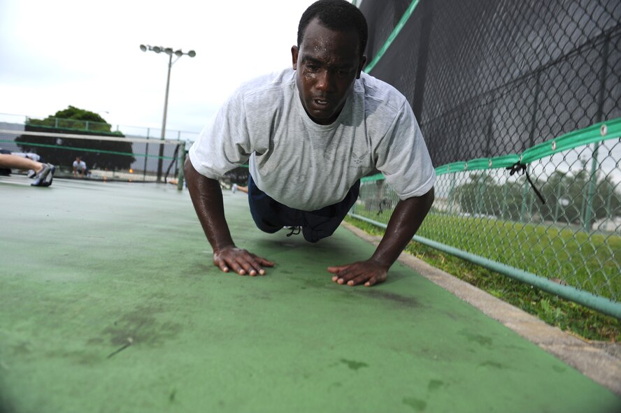 Tech Sgt. Bronkelly Porter does pushups at a squadron PT session, Oct. 15. The 390th Intelligence Squadron combines elements inspired by P90X and Crossfit with traditional exercise techniques for a well-rounded PT program, resulting in better total-body fitness. (U.S. Air Force Photo/Tech. Sgt. Jason W. Edwards)