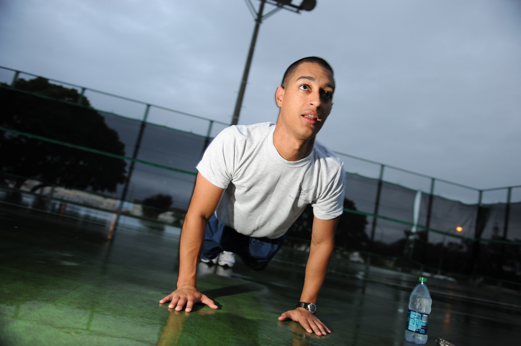 Senior Airman Kenneth Amaro Vega does pushups at a squadron PT session, Oct. 15. The 390th Intelligence Squadron combines elements inspired by P90X and Crossfit with traditional exercise techniques for a well-rounded PT program, resulting in better total-body fitness. (U.S. Air Force Photo/Tech. Sgt. Jason W. Edwards)