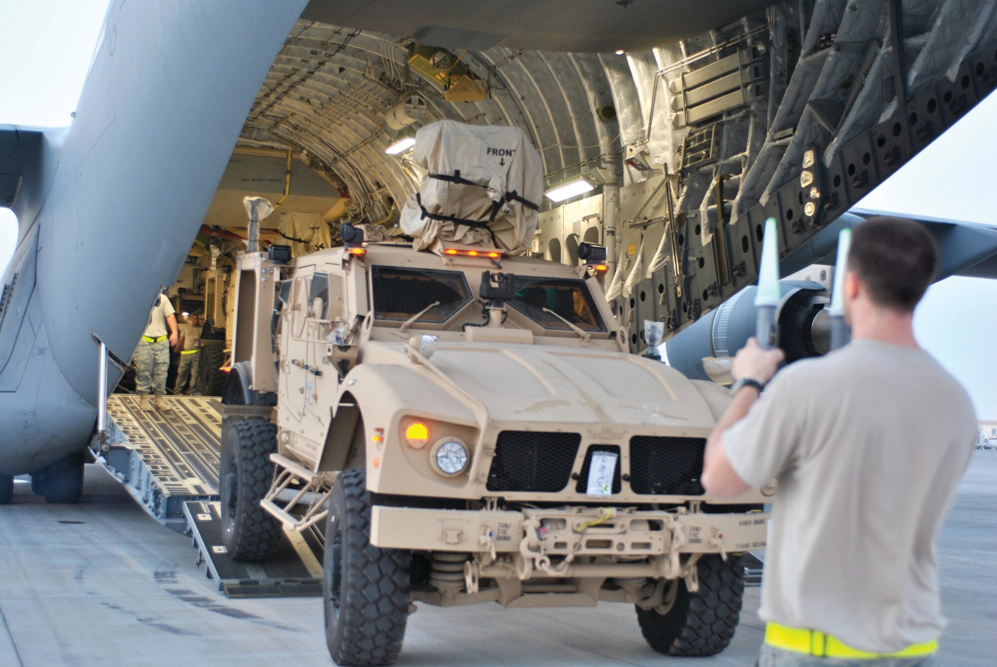 Airmen from ISA AB are up at the crack of dawn loading M-ATVs onto a C-17. The main mission for Airmen at Isa was to prepare hundreds of M-ATVs during a surge for shipment to the area of responsibility. (U.S. Air Force photo/ Staff. Sgt. Nika Glover)