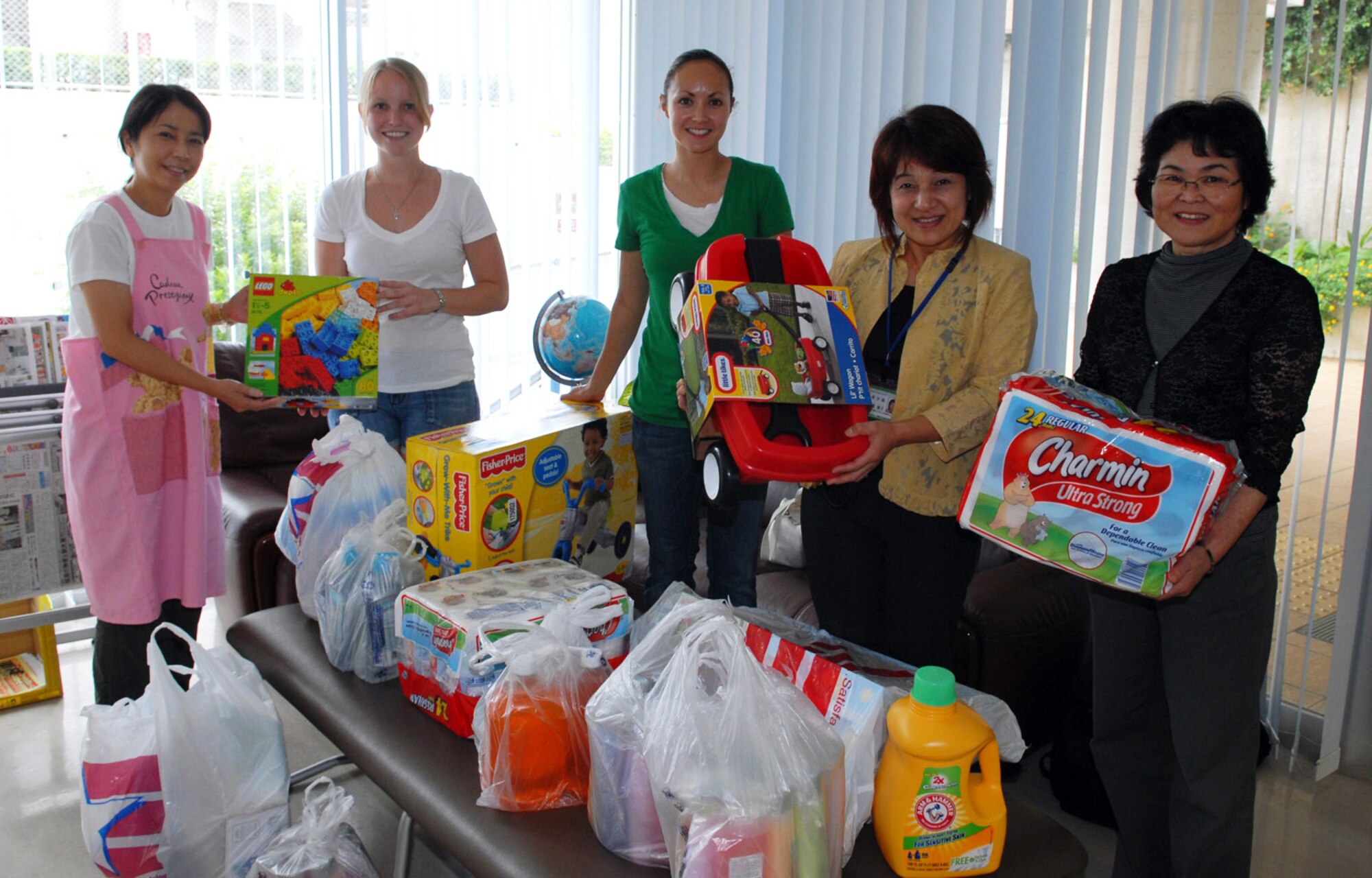 Donations from the 390th Intelligence Squadron are presented to the Urawa Ryo single mother home at Urasoe city on Oct. 12, 2010. (U.S Air Force photo/Junko Kinjo)