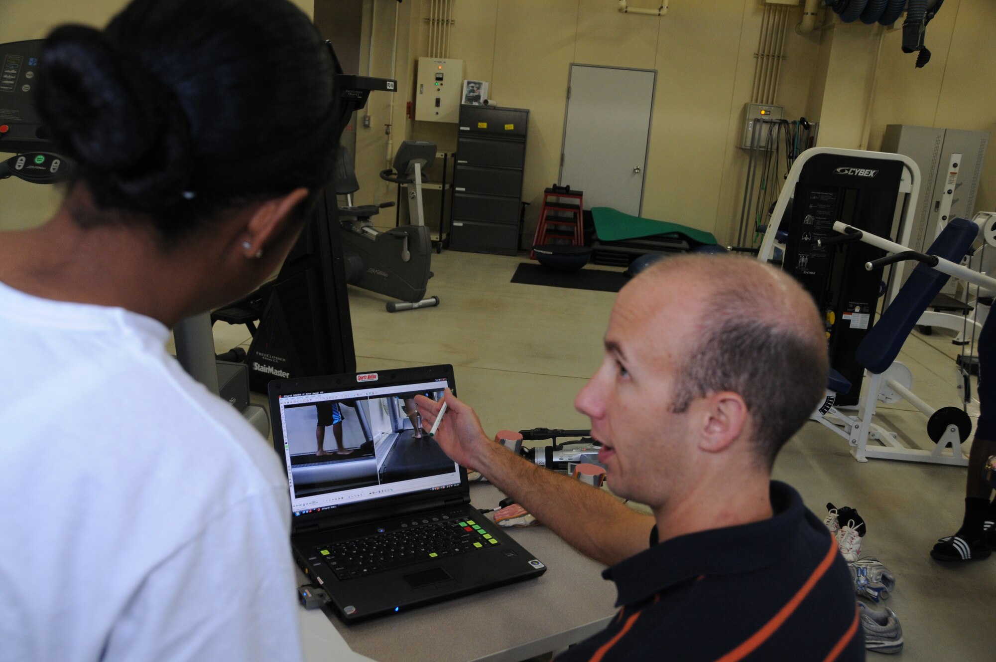 Lindsay Buckalew, right, 35th Aerospace Medicine Squadron exercise physiologist, shows a Misawa member the result of her gait analysis performed at the Health and Wellness Center Sept. 24, 2010, at Misawa Air Base, Japan. The gait analysis takes only minutes to do. The evaluator sends the runner away knowing what type of runner they are and a list of running shoes made for their run type.