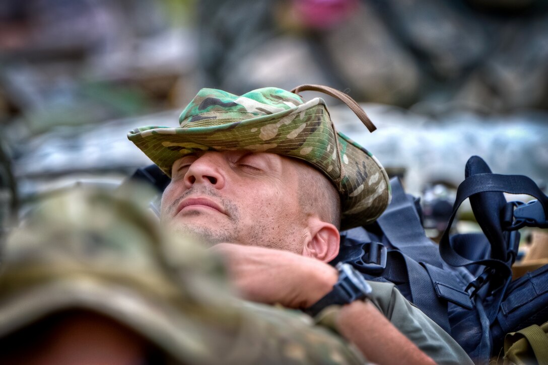 U.S. Coast Guard Senior Chief Petty Officer Thomas Bowes takes a break during the International Sniper Competition on Selby Hill, Fort Benning, Ga., Oct. 12, 2010.
