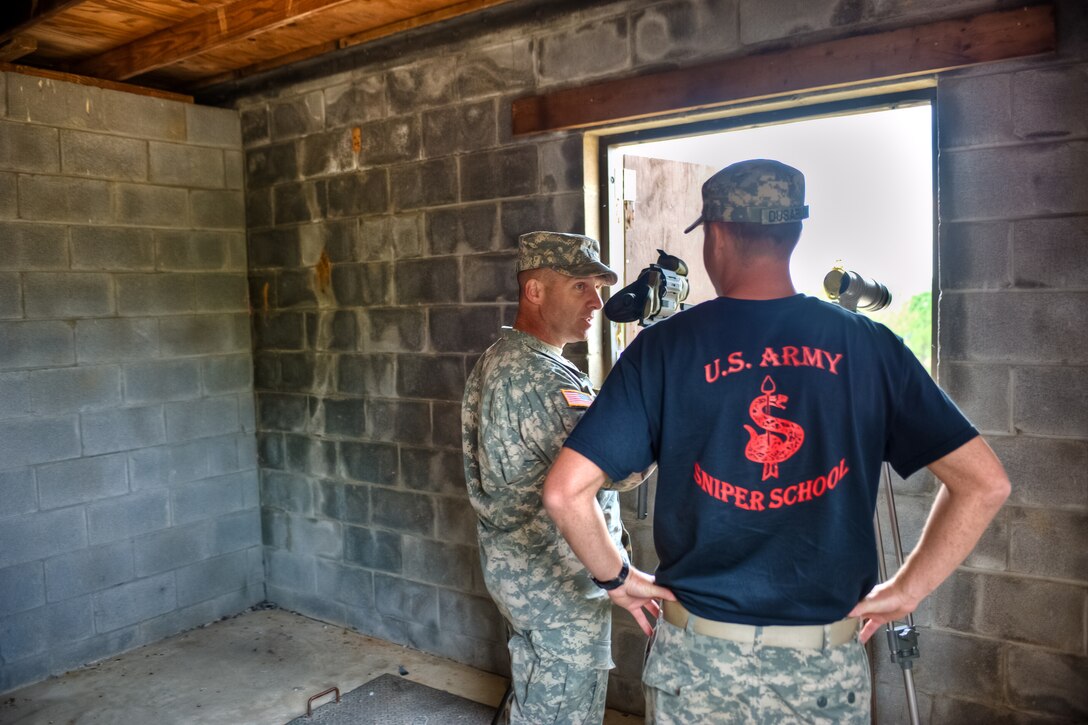 U.S. Army Cpt. Michael Dusablon, right, the sniper school's company commander, briefs U.S. Army Brig. Gen. Bryan Owens before the start of the International Sniper Competition on Selby Hill, Fort Benning, Ga., Oct. 13, 2010. Dusablon is the sniper school's company commander and Owens is the school commandant assigned to the 3rd Infantry Division's 3rd Brigade Combat Team.