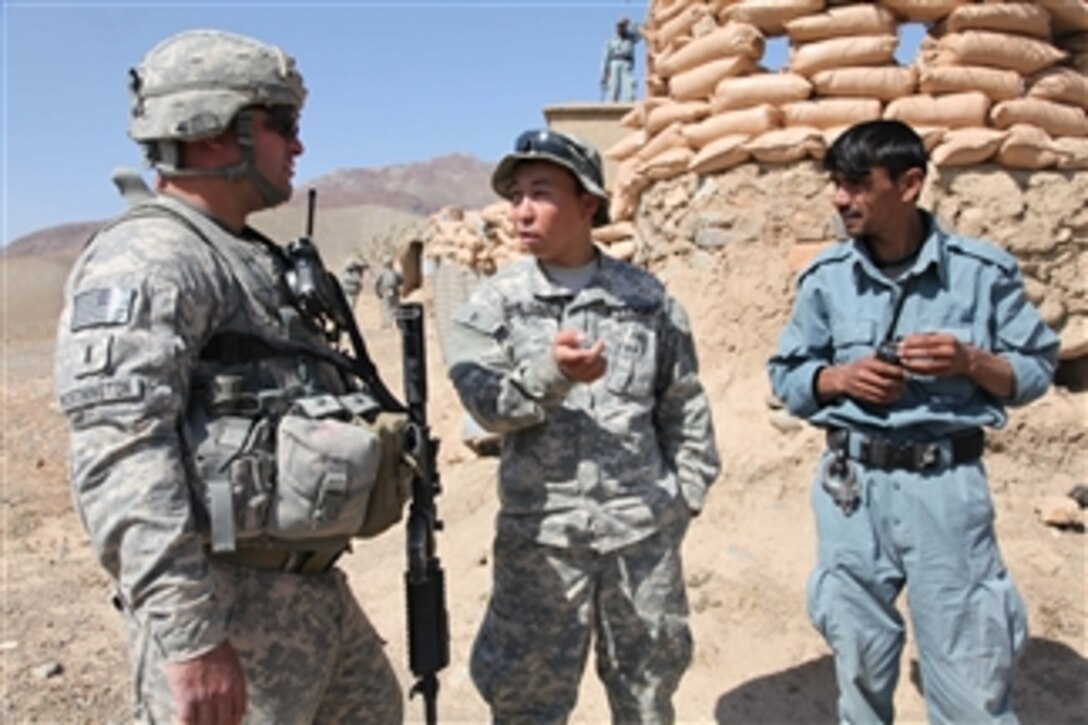 U.S. Army 1st Lt. Paul Worthington (left), a cavalry officer with 1st platoon, Bravo Troop, 1st Squadron, 172nd Cavalry Regiment, listens to an interpreter while speaking with an Afghan National Policeman about security issues during a visit to a National Police outpost in the Jabal Saraj district of the Parwan province of Afghanistan on Oct. 8, 2010.  Soldiers with Worthington’s unit visited the outpost to check on security forces and to conduct an area recon.  