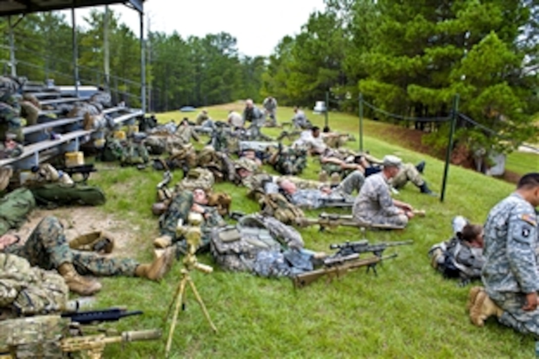 Competitors from around the world take a break during the "loophole" event at the International Sniper Competition on Selby Hill, Fort Benning, Ga., Oct. 12, 2010.