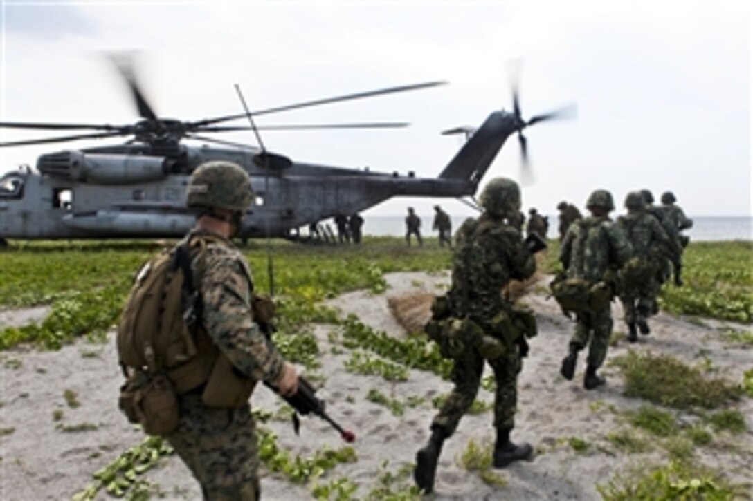 U.S. and Philippine Marines enter a CH-53E Sea Stallion helicopter at the end of a bilateral beach landing in San Miguel, Philippines, Oct. 10, 2010. The Marines are assigned to Animal Company, Battalion Landing Team, 1st Battalion, 7th Marine Regiment, 31st Marine Expeditionary Unit, which conducted a bilateral mechanized amphibious landing with the Philippine Marine Corps, allowing both Marine forces to share experiences.
