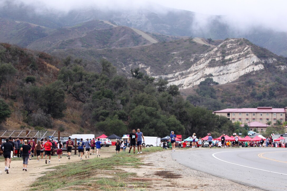 Participants of the 2010 Camp Pendleton Buffalo Alley 10k, 5k and 1k Race run by the obstacle course in the 52 Area, Oct. 16. The event, that honored the fallen and wounded heroes who serve our country, had designated food and entertainment areas for spectators, awards for participants, and music for everyone.