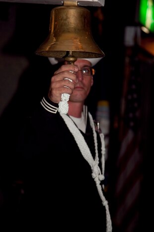 A U.S. Sailor rings a bell as the guest's of honor enter the banquest hall during the U.S. Navy ball, Marine Corps Air Station Iwakuni, Japan, October 15, 2010. Sailors gathered for the 235th birthday ball of the U.S. Navy to celebrate the Navy's traditions and history.