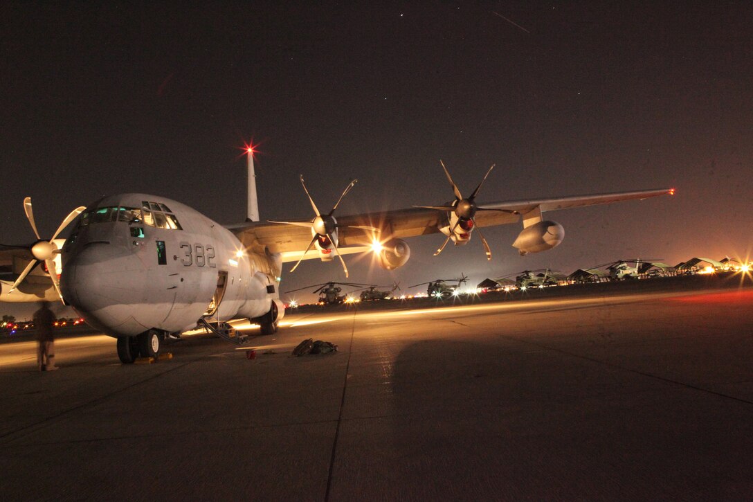 A U.S. Marine Corps KC-130 Hercules plane sits on the flight line of Marine Corps Air Station in Yuma, Ariz., on the evening of Oct. 15, 2010, after flying in a training mission as part of Weapons and Tactics Instructor Course. The course, hosted twice a year in Yuma by Marine Aviation and Weapons Tactics Squadron 1, trains Marine students from across the globe to return to their units as training officers versed in the latest aviation tactics and procedures. The versatile KC-130s are often used for aerial refueling of jets and helicopters, as well as transporting troops and gear.