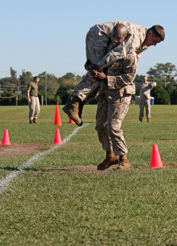 Gunnery Sergeant Arthur L. Rainey Jr., 22nd Marine Expeditionary Unit combat camera chief and Gould, Ark., native, carries a Marine for a distance of 65 yards during the fireman's carry segment in the maneuver under fire portion of a Combat Fitness Test aboard Camp Lejeune, N.C., Oct. 15, 2010. The CFT incorporates two other physical elements, which are movement to contact, an 880-yard boots and utilities run; and the ammunition can lift.  The MEU completed the CFT as part of the Marine Corps' annual training requirements.