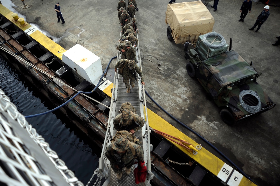 Marines of the 31st Marine Expeditionary Unit board the USS Harpers Ferry (LSD 49) as they begin their backload.  Due to the impending typhoon, the USS Essex (LHD 2), the USS Denver (LPD 9), the USS Harpers Ferry (LSD 49) with the 31st MEU aboard departed Subic Bay.  Super Typhoon Megi, a Category 5 storm, made landfall in the northern Luzon area of the Philippines on Sunday. The ESX ARG and 31st MEU were in the Philippines participating in the annual Amphibious Landing Exercise.  PHIBLEX is a regularly-scheduled exercise focusing on the interoperability of the service members of the armed forces of the Philippines and U.S. military personnel.  The exercise provides bilateral training between the two military forces to maintain readiness, improve interoperability, security assistance and humanitarian assistance and disaster relief training.