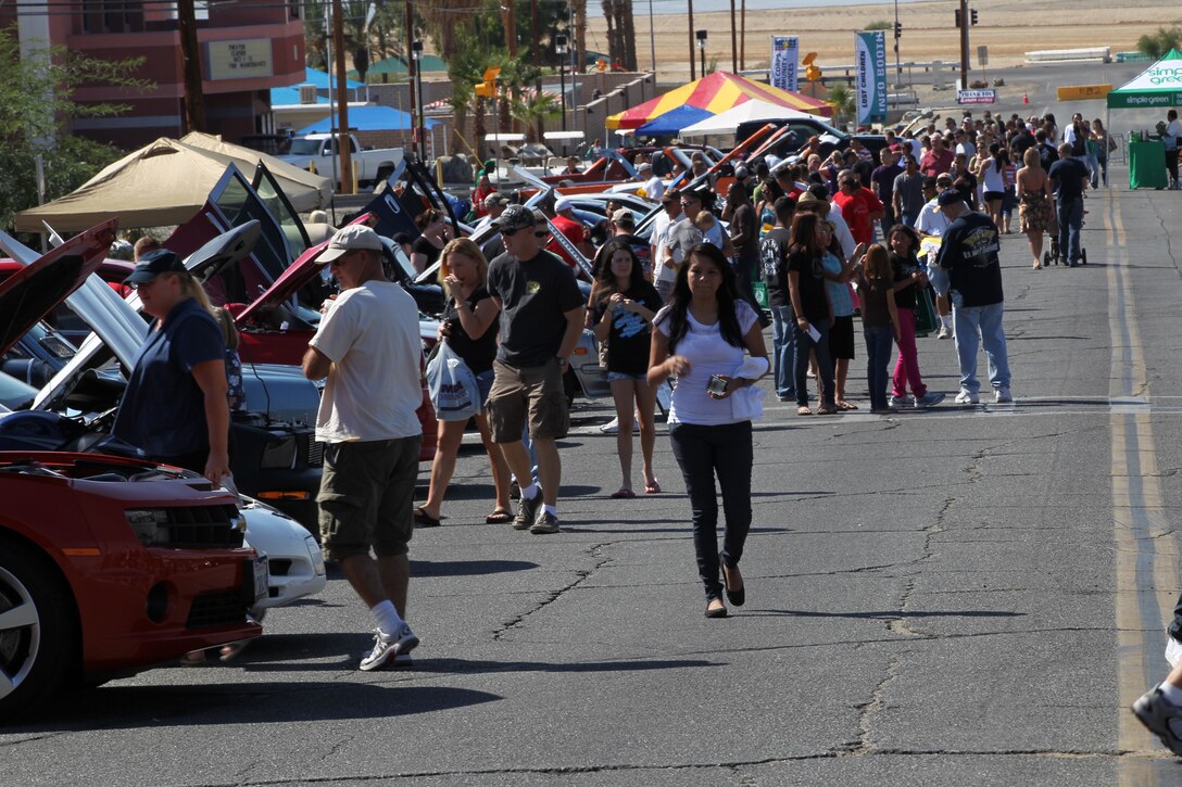 Patrons enjoy the Commanding General’s Car and Bike show entries Saturday aboard the Combat Center. Across the street however, was a less static display put on by three members of the Metal Mulisha Troops for the installation.::r::::n::