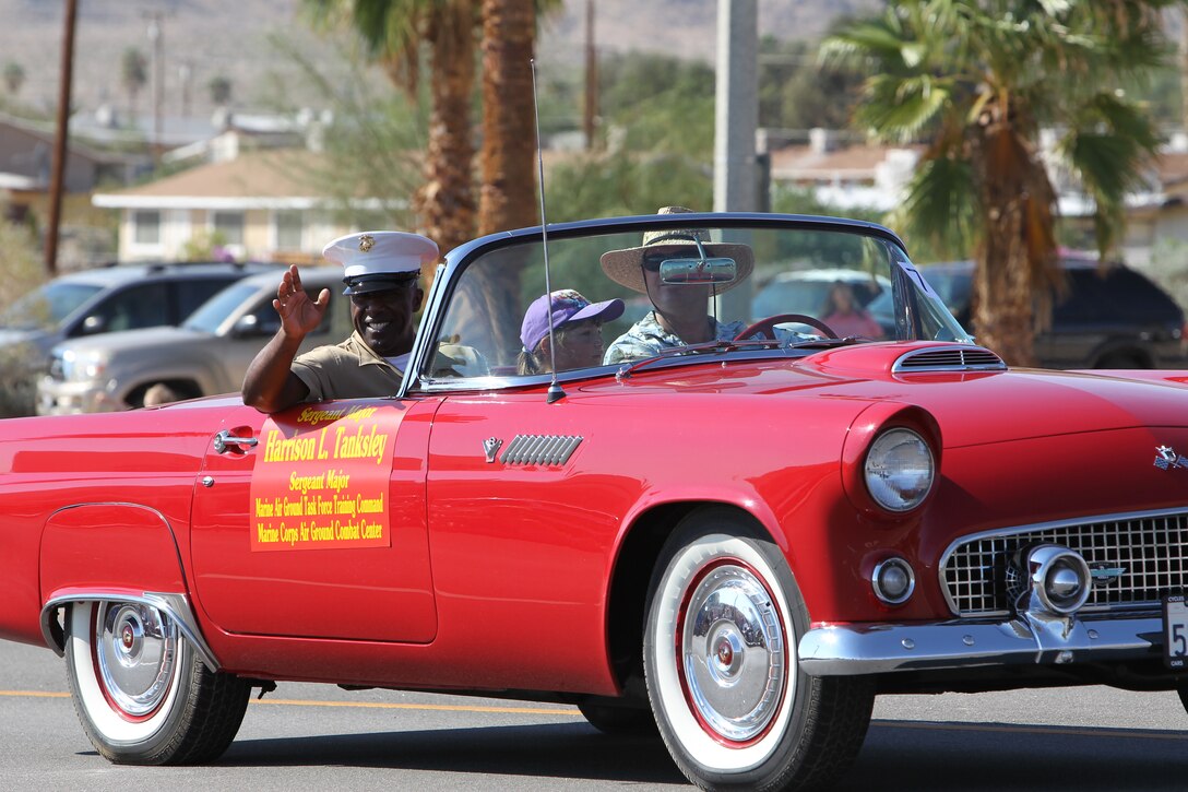 Sergeant Maj. Harrison L. Tanksley, the Combat Center’s sergeant major, waves to spectators during the 74th annual Pioneer Days Parade in Twentynine Palms, Calif., Saturday.::r::::n::