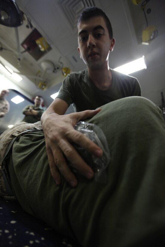 Lance Cpl. Caleb Cline, a data network specialist with Marine Medium Tiltrotor Squadron 266 (Reinforced), 26th Marine Expeditionary Unit, patches a mock exit wound on Lance Cpl. Lauren Simms, radio operator for VMM-266 (Rein), 26th MEU, during combat lifesaver training aboard USS Kearsarge, Oct. 15, 2010. 26th MEU is currently embarked aboard the ships of Kearsarge Amphibious Ready Group and conducting training in the 5th Fleet area of responsibility.