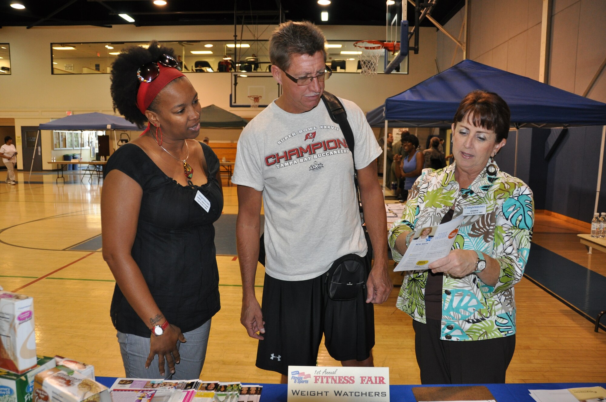 Dareyl Coleman (left) and Debbie Brooks, Weight Watchers leaders, speak with Col. Robert Stormes, 452nd Maintenance Group commander, at the March Fitness Fair, Oct. 2. (U.S. Air Force photo by Master Sgt. Linda Welz)