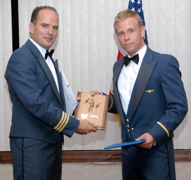 WRIGHT-PATTERSON AIR FORCE BASE, Ohio -- Royal Netherlands air force Lt. Col. Maurice Shonk, the Senior National Representative, presents a Royal Netherlands air force student pilot with his  graduation gift during the 178th Fighter Wing F-16 Fighting Falcon Initial Qualification Training class graduation held at the Wright-Patterson Club, Ohio, October 9. The four graduates from the Royal Netherlands air force are the last to graduate from Springfield Air National Guard Base, Ohio.