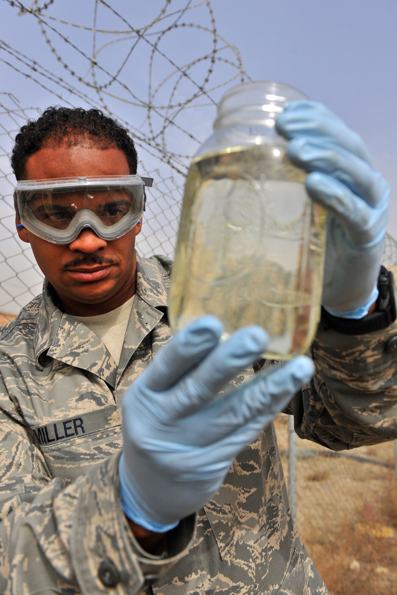 Tech Sgt. Kerry Miller, the 455th Expeditionary Logistics Readiness Squadron non-commissioned officer in charge of the laboratory and day shift distribution supervisor, performs a visual inspection of a fuel sample at Bagram Air Field, Afghanistan, Oct. 14, 2010. The inspection ensures quality of the fuel by ensuring that no debris or water has contaminated the fuel. The Petroleum Oils and Lubricants flight, ranked fourth in the Air Force for most gallons pumped, pumps 8 to 9 million gallons monthly worth about $16 million. Sergeant Miller is a native of Harrisburg, Pa. (U.S. Air Force photo/Staff Sgt. Christopher Boitz)