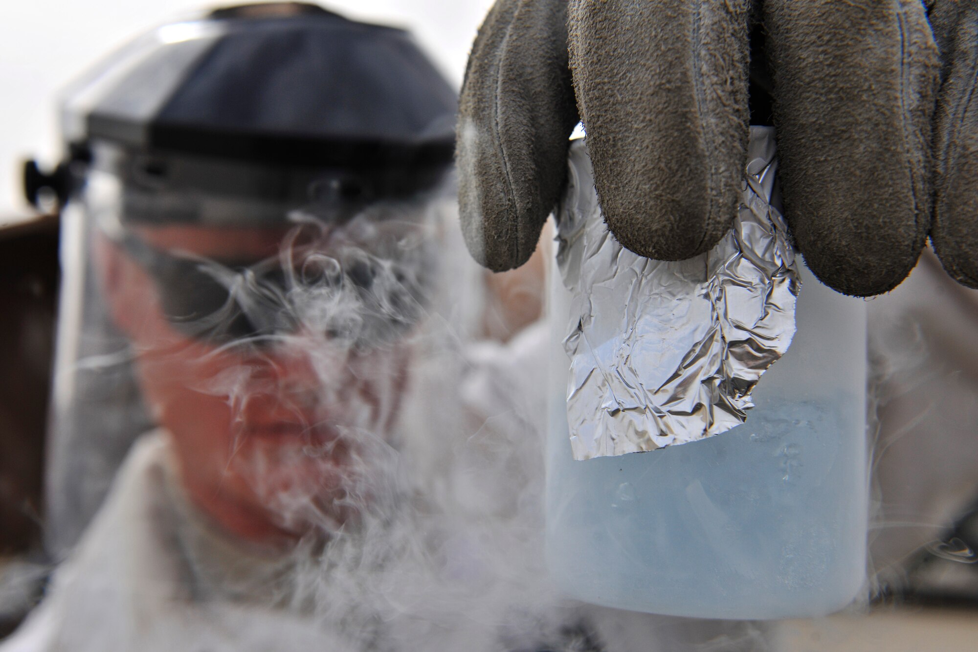 Airman 1st Class Dustin Henke, assigned to the Petroleum Oils and Lubricants flight, 455th Expeditionary Logistics Readiness Squadron, examines a liquid oxygen sample for odors and debris prior to releasing it to use in aircrafts at Bagram Air Field, Afghanistan, Oct. 14, 2010. LOX, stored at -297 degrees Fahrenheit, is used in aircraft for aviators to breathe and has recently been used in helicopters to supply casualties with oxygen while being transported. The Petroleum Oils and Lubricants flight, ranked fourth in the Air Force for most gallons pumped, pumps 8 to 9 million gallons monthly worth about $16 million. Airman Henke is a native of Waverly, Minn. (U.S. Air Force photo/Staff Sgt. Christopher Boitz)