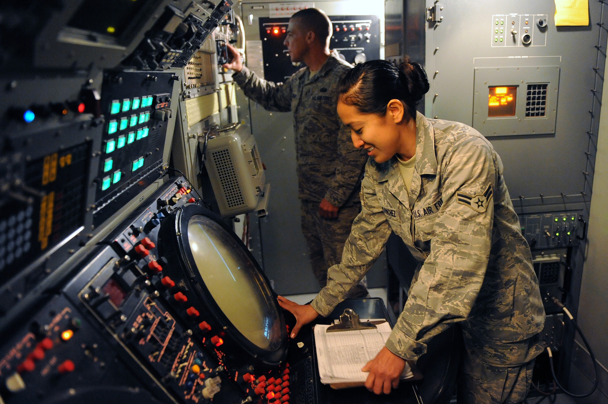 Airman 1st Class Diana Garcia-Sanchez and Staff Sgt. Sean Stromer perform a radar check to verify aircraft reflections are discernable, Oct. 14, 2010, at Kandahar Airfield, Afghanistan.  Airman Garcia-Sanchez is a ground radar system apprentice, and Sergeant Stromer is the assistant NCO in charge of ground radar systems. Both are assigned to the 73rd Expeditionary Air Control Squadron. (U.S. Air Force photo by Tech. Sgt. Chad Chisholm/Released)   