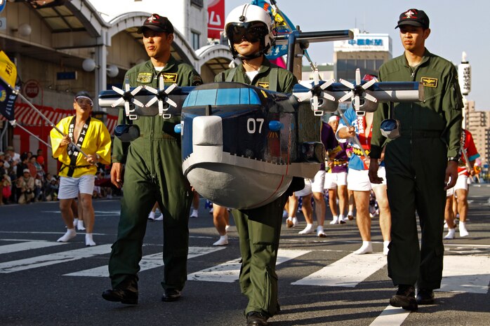 Japan Maritime Self-Defense Force members parade down the street during the closing parade of the 54th annual Iwakuni Festival hosted in the downtown area by the train station Sunday. JMSDF members set up a tent along side Iwakuni based Marines during the festival to shake hands and take pictures with the local community.