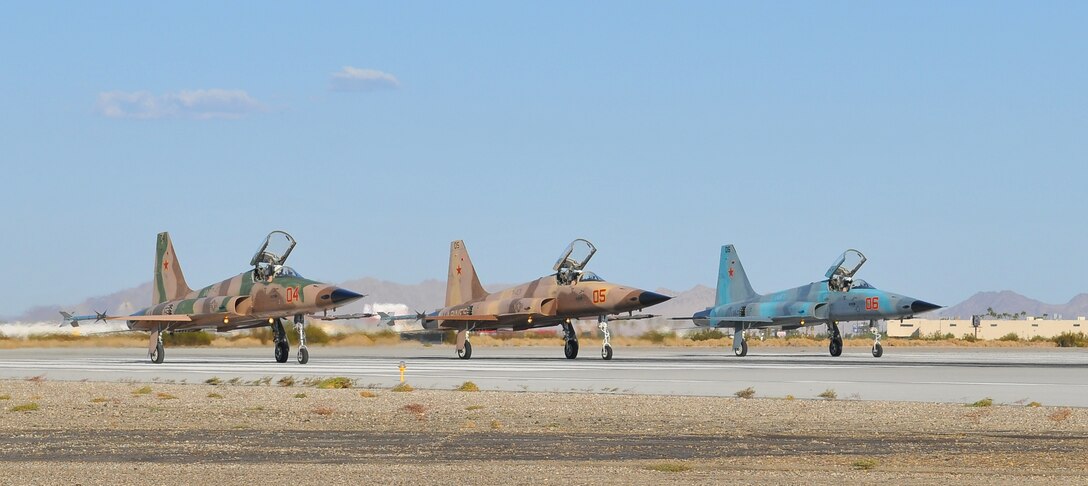 Participating in the semiannual Weapons and Tactics Instructor course, three F-5 Tiger II jets assigned to Marine Fighter Attack Training Squadron 401 line up prior to take off from the flight line of the Marine Corps Air Station in Yuma, Ariz., on Oct. 16, 2010. As the Marine Corps’ only squadron to fly the F-5 jets, the pilots of VMFT-401 portray enemy aircraft for pilots training in Yuma. WTI, hosted by Marine Aviation Weapons and Tactics Squadron 1, trains Marine students from across the globe to return to their units as training officers versed in the latest aviation tactics and procedures.