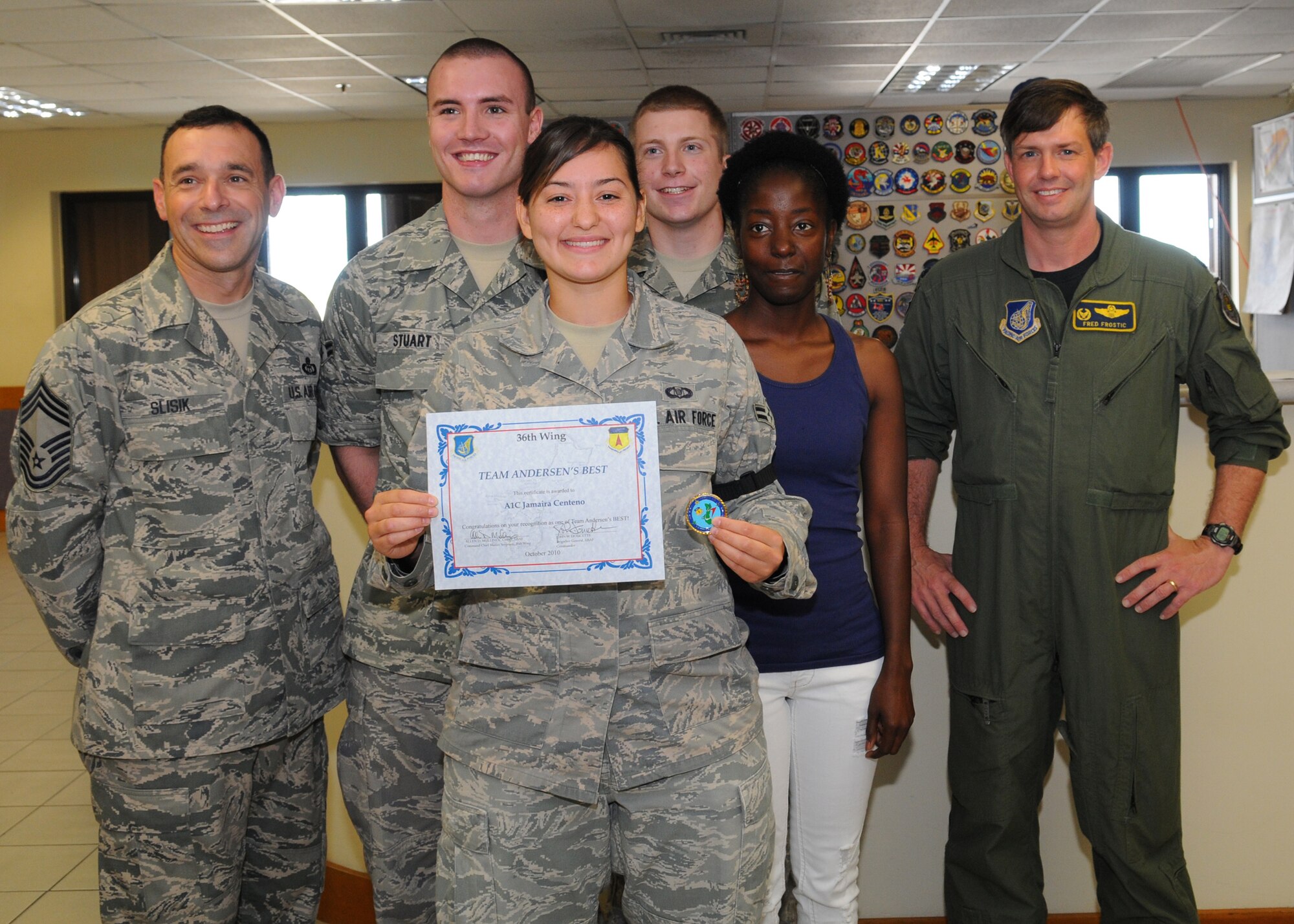Airman 1st Class Jamaira Centeno, 36th Operations Support Squadron, Airfield Management operations coordinator poses for a photo with her coworkers after being awarded Andersen's Best, Oct. 12 at Andersen Air Force Base, Guam.(U.S. Air Force photo/ Senior Airman Nichelle Anderson)