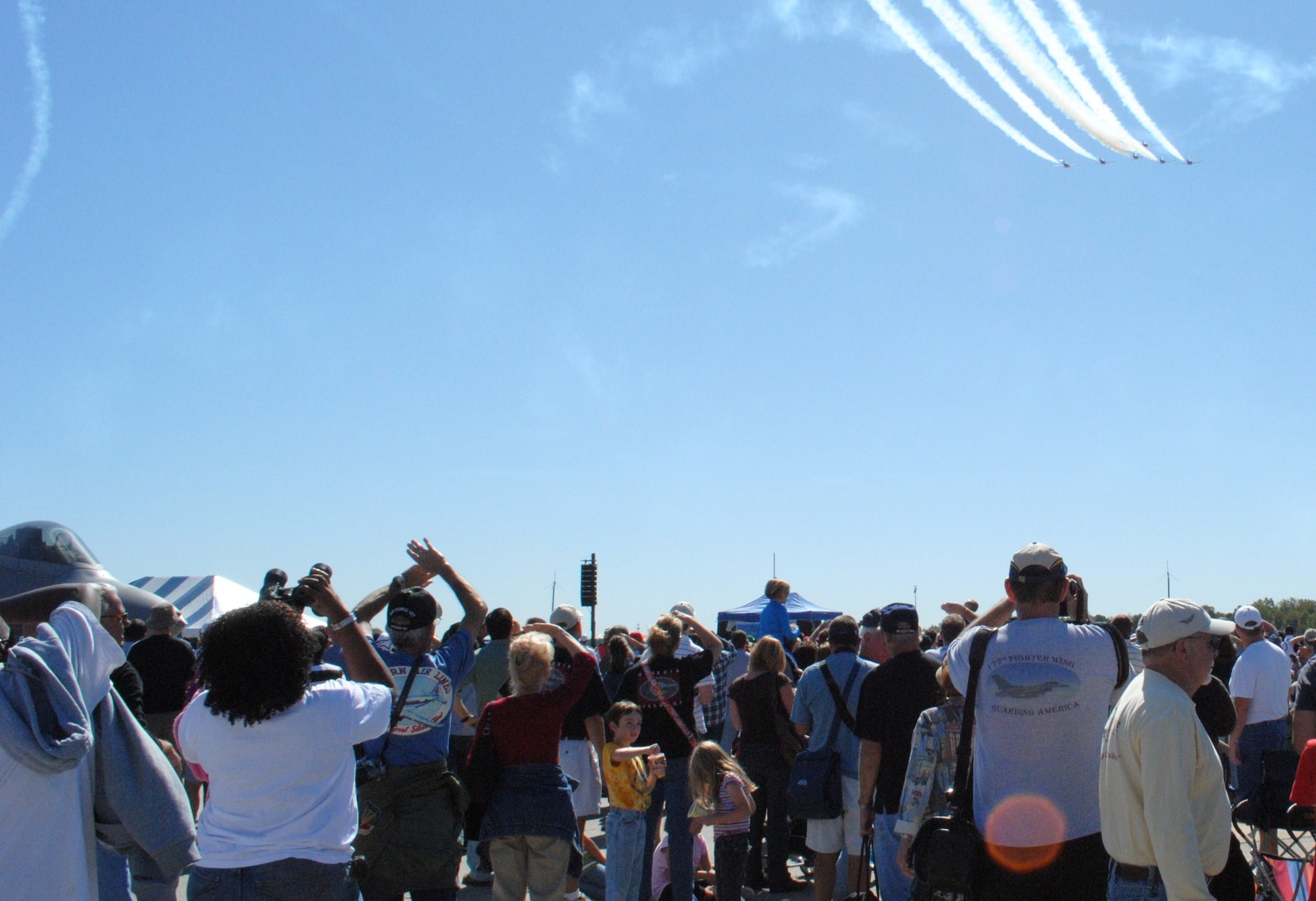 Armed with binoculars,video cameras, and a set of hands over the eyes, air show enthusiasts kept watch on the Snowbirds during their air performance at Wings Over Atlanta.  (U.S. Air Force photo/Master Sgt. Stan Coleman)