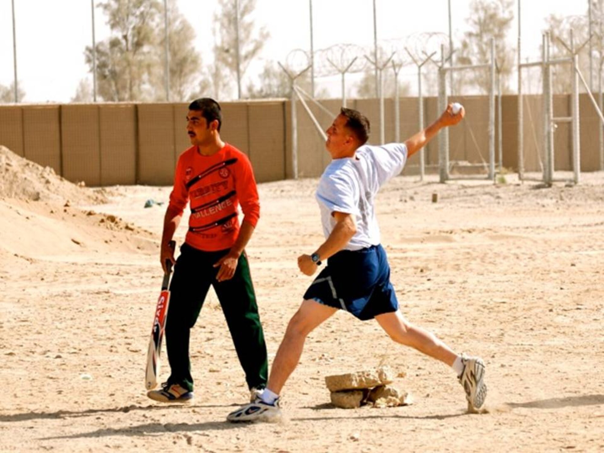 KANDAHAR, Afghanistan - Members of NATO Air Training Command - Afghanistan and the Afghan Air Force Kandahar Air Wing play cricket on Oct 14, 2010.  (U.S. Military photo/RELEASED).