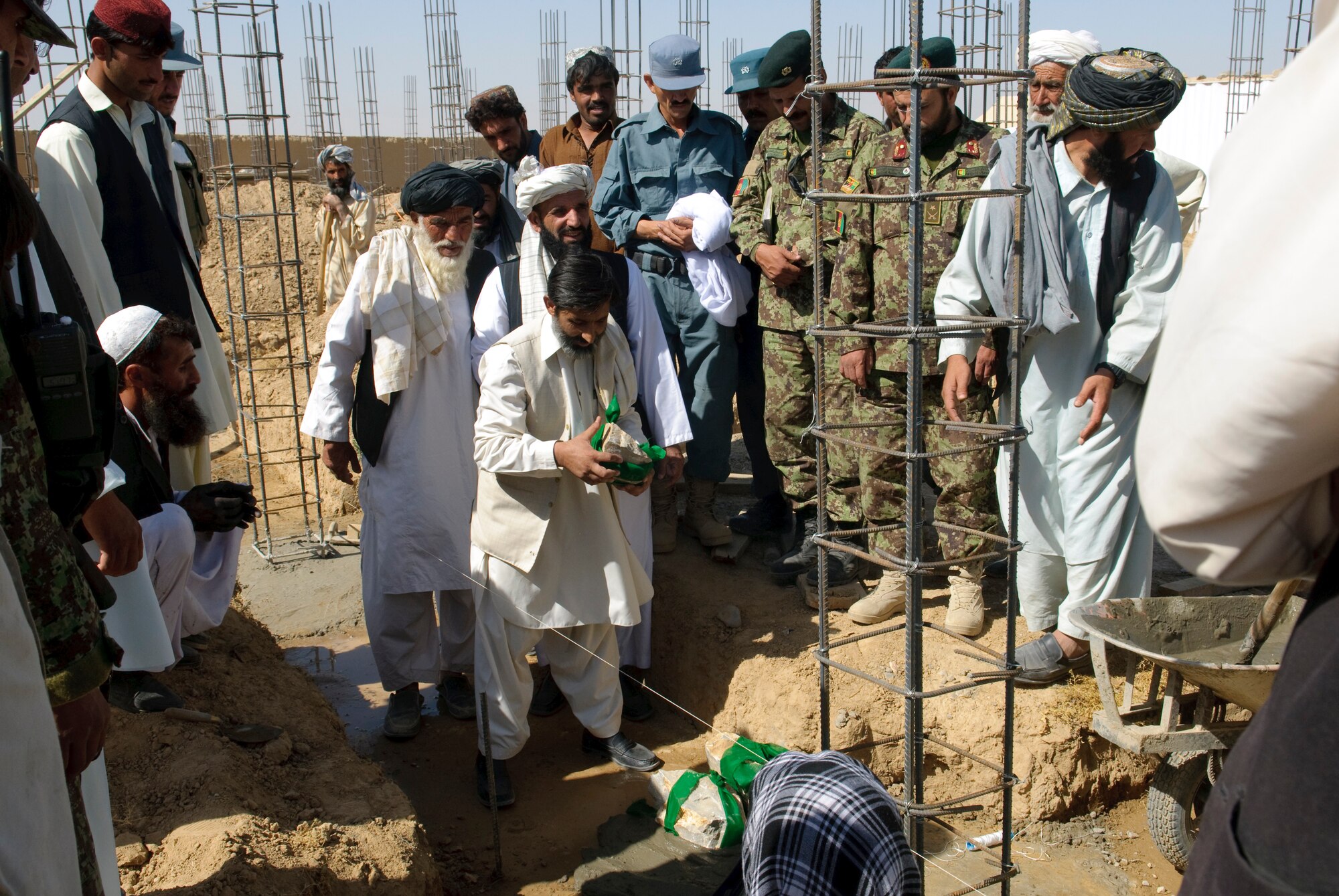 QALAT CITY, Afghanistan -- A local official lays a stone during a cornerstone laying ceremony for the new Surri Comprehensive Health Clinic near Forward Operating Base Wolverine, Zabul Province, Oct. 15, 2010. The clinic will provide outpatient care, immunizations, basic laboratory practices and five beds for inpatient care. (U.S. Air Force photo/Senior Airman Nathanael Callon/Released)