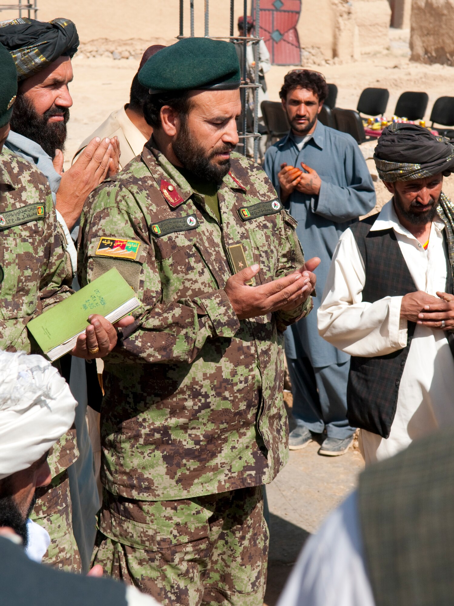 QALAT CITY, Afghanistan -- An Afghan National Army officer prays during a cornerstone laying ceremony for the new Surri Comprehensive Health Clinic near Forward Operating Base Wolverine, Zabul Province, Oct. 15, 2010. The clinic will provide outpatient care, immunizations, basic laboratory practices and five beds for inpatient care. (U.S. Air Force photo/Senior Airman Nathanael Callon/Released)