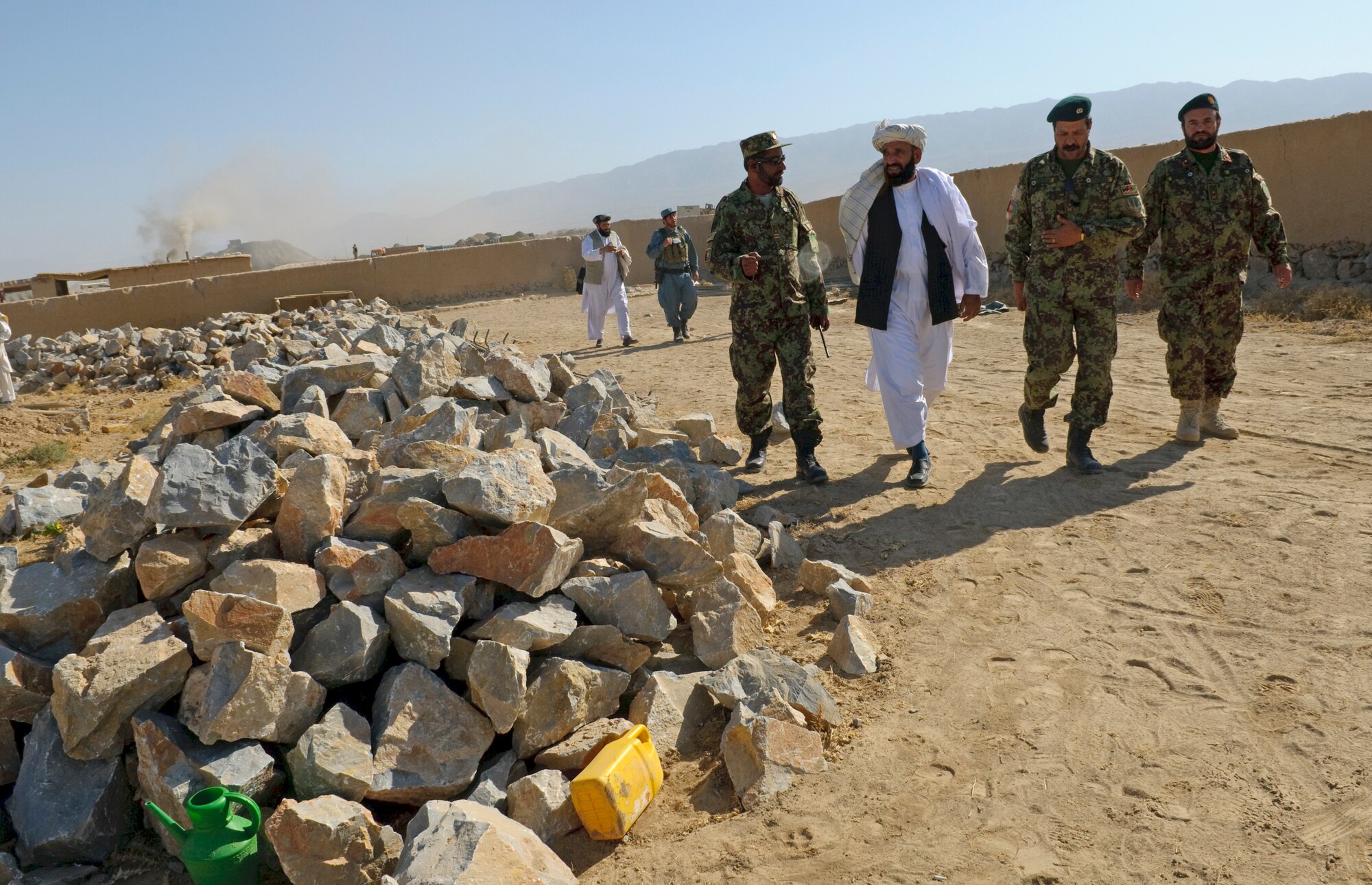 QALAT CITY, Afghanistan -- Zabul Deputy Governor Haji Gulab Shah walks around the Surri Comprehensive Health Clinic construction site with Afghan National Army officers during a cornerstone laying ceremony for the clinic near Forward Operating Base Wolverine, Zabul Province, Oct. 15, 2010. The clinic will provide outpatient care, immunizations, basic laboratory practices and five beds for inpatient care. (U.S. Air Force photo/Senior Airman Nathanael Callon/Released)
