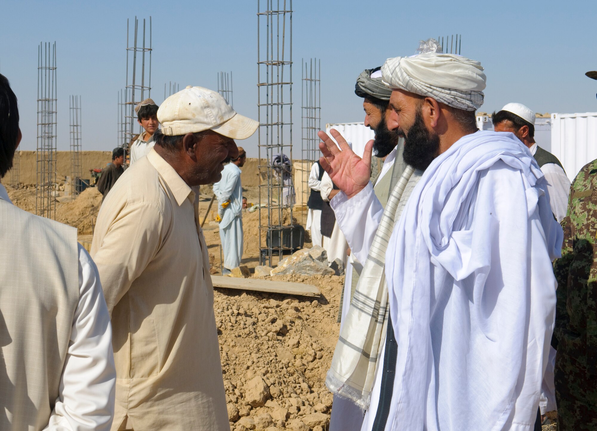 QALAT CITY, Afghanistan -- Zabul Deputy Governor Haji Gulab Shah, right, greets an Afghan man during a cornerstone laying ceremony for the new Surri Comprehensive Health Clinic near Forward Operating Base Wolverine, Zabul Province, Oct. 15, 2010. The clinic will provide outpatient care, immunizations, basic laboratory practices and five beds for inpatient care. (U.S. Air Force photo/Senior Airman Nathanael Callon/Released)