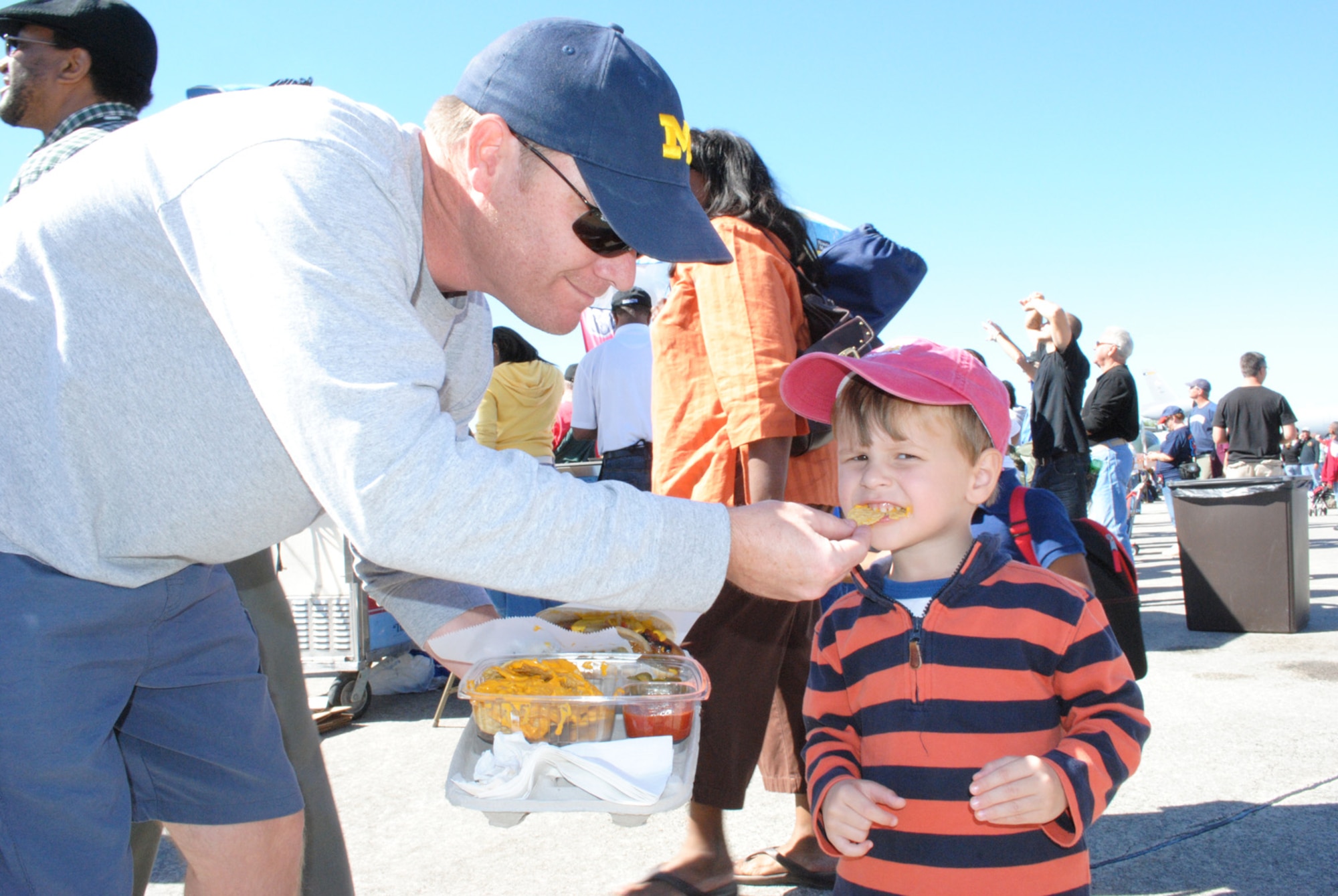 Three-year-old Charlies, son of Mr. Bill Bendon, enjoys his dad's cheese nachos snack during the Wings Over Atlanta Air Show Oct. 16.  "This air show has a lot more planes and better aerobatics than the last air show we attended in Ohio," said Mrs. Ericka Bendon, Charlie's mother.  (U.S. Air Force photo/Master Sgt. Stan Coleman)