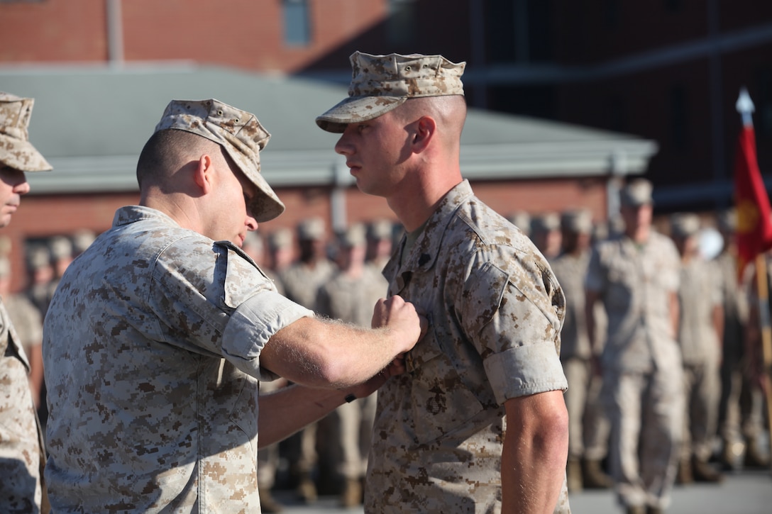Lt. Col. Jeffrey Rule (left), commanding officer of Infantry Training Battalion, School of Infantry-East, pins the Bronze Star medal with a combat distinguishing device on Sgt. Daniel Hubbert (right), a combat instructor for Company D, ITB, SOI-East, during a ceremony aboard Camp Geiger, Oct. 18. Hubbert earned the award for his actions while deployed to Now Zad, Afghanistan, with 3rd Battalion, 8th Marine Regiment, 2nd Marine Division, in support of Operation Enduring Freedom.