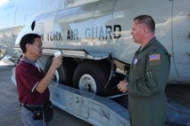 JOINT BASE PEARL HARBOR-HICKAM, Hawaii - Burt Lum, host of Hawaii Public Radio "Byte Marks Cafe," interviews Col. Gary James, 109th Operations Group commander, about the LC-130 Hercules here, Oct. 18. The LC-130 is on its way to Antarctica for Operation Deep Freeze. Its unique skis allow the air craft to perform operations in snow conditions. (U.S. Air Force photo/Senior Airman Gustavo Gonzalez)