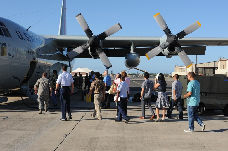 JOINT BASE PEARL HARBOR-HICKAM, Hawaii - An LC-130 Hercules parks on the Hickam flightline while local media takes photos here, Oct. 18. The LC-130 is on its way to Antarctica for Operation Deep Freeze. Its unique skis allow the air craft to perform operations in snow conditions. (U.S. Air Force photo/Senior Airman Gustavo Gonzalez)