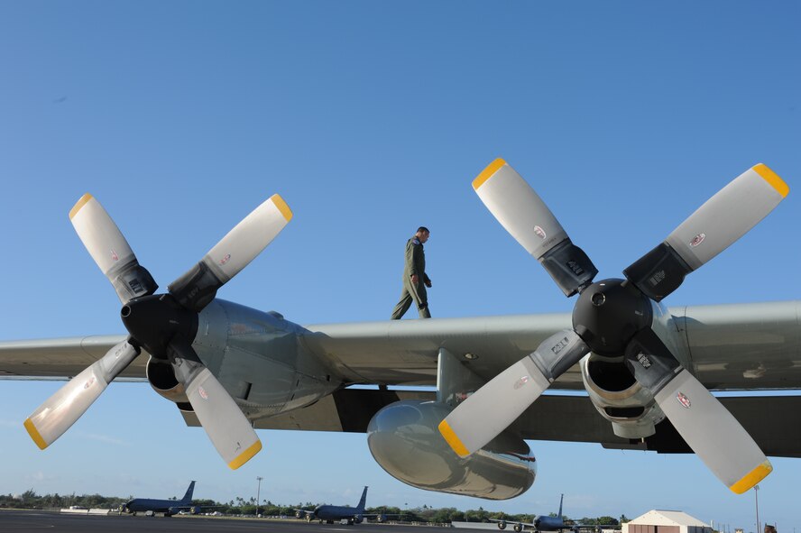 JOINT BASE PEARL HARBOR-HICKAM, Hawaii - A 109th Air Craft Maintenance Squadron crew chief from Stratton Air National Guard Base, N.Y., does his routine pre-flight inspections on an LC-130 Hercules here, Oct. 18. The LC-130 is on its way to Antarctica for Operation Deep Freeze. Its unique skis allow the air craft to perform operations in snow conditions. (U.S. Air Force photo/Senior Airman Gustavo Gonzalez)