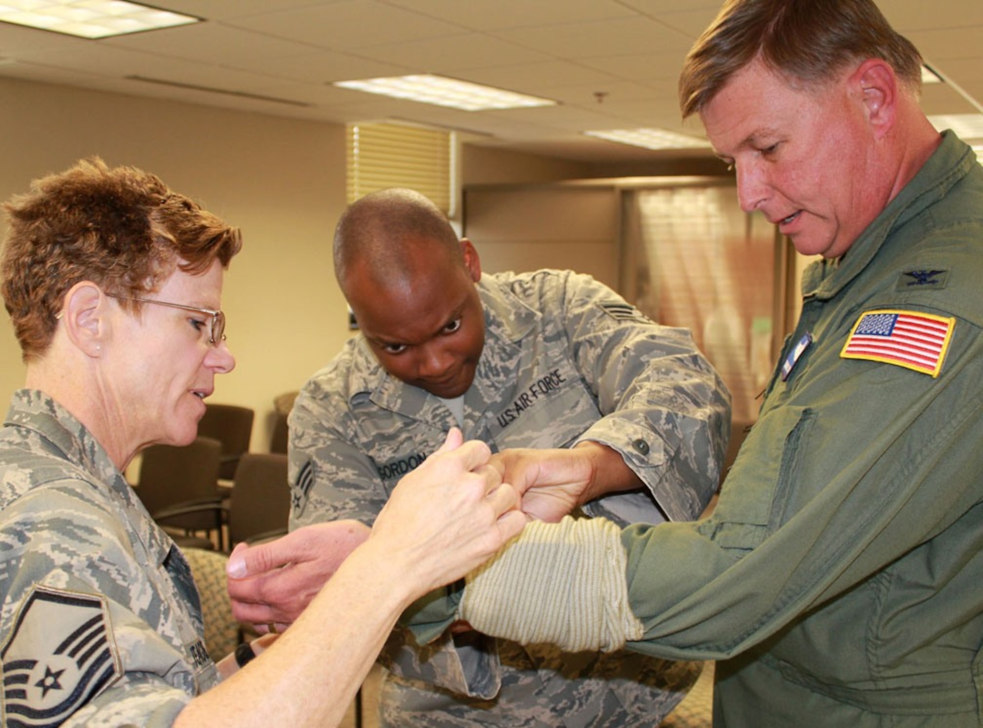 Master Sgt. Deb Teague teaches Self Aid Buddy Care to Senior Airman Michael Gordon. 932nd Airlift Wing members spent the UTA weekend preparing for an upcoming ORI. Col. Douglas Schwartz, 932nd vice-commander, was the "patient."  (U.S. Air Force photo/Maj. Stan Paregien)