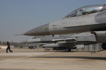 Senior Airman Jonicko Dela Cruz, 51st Aircraft Maintenance Squadron, signals for an F-16 Fighting Falcon aircraft piloted by Lt. Col. Jon Wilkinson, 51st Operations Support Squadron commander, to begin taxiing during exercise Max Thunder 10-02 Oct. 18 at Kwangju Air Base, Republic of Korea. Both Airmen are from Osan Air Base, ROK. (U.S. Air Force photo/Staff Sgt. Eric Burks)