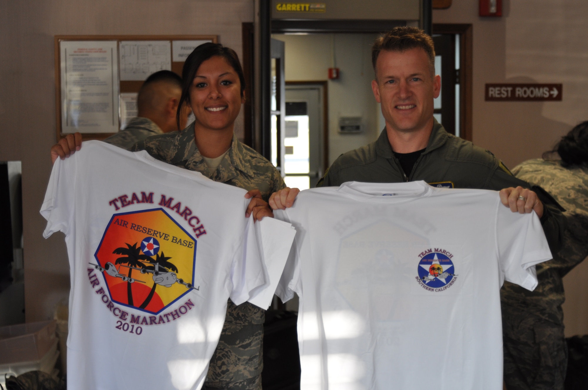 Staff Sgt. Alicia Salas and Lt. Col. Kris Kraiger display the Team March Air Force Marathon t-shirt. (U.S. Air Force photo by LInda Welz)