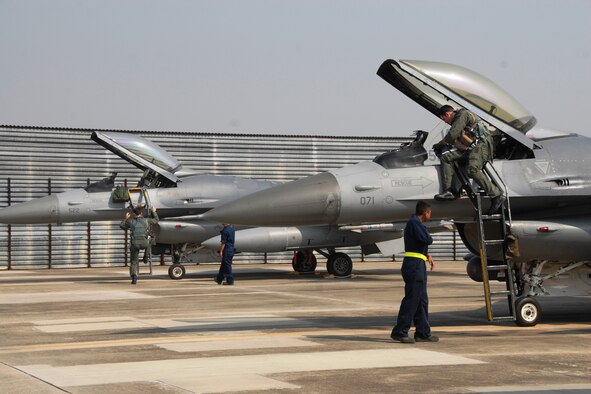 Pilots from Kunsan Air Base, Republic of Korea, climb aboard their F-16 Fighting Falcon aircraft Oct. 18 at Kwangju Air Base, ROK, during exercise Max Thunder 10-02. (U.S. Air Force photo/Staff Sgt. Eric Burks)