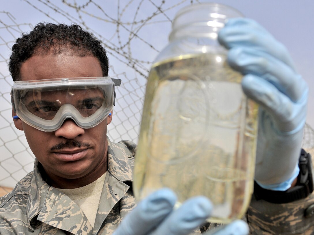 Tech Sgt. Kerry Miller performs a visual inspection of a fuel sample Oct. 14, 2010, at Bagram Airfield, Afghanistan. Pentagon officials are stressing the increasing need to shift toward renewable energy sources to reduce dependence on fossil fuels and increase battlefield readiness. Sergeant Miller is the NCO in charge of the 455th Expeditionary Logistics Readiness Squadron at Bagram Airfield. (U.S. Air Force photo/Staff Sgt. Christopher Boitz)
