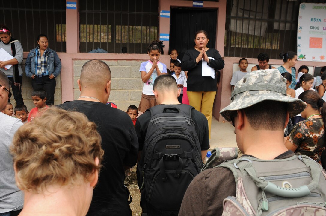 SAN JERONIMO, Honduras --  Standing before Joint Task Force-Bravo members and local villagers, a local girl leads the group in prayer during the Chapel Hike here Oct. 16. According to the JTF-Bravo chaplain's office, the monthly hikes build and foster positive relationships with the Honduran people and strength JTF-Bravo’s commitment to the Honduran government to provide humanitarian assistance. (U.S. Air Force photo/Tech. Sgt. Benjamin Rojek)