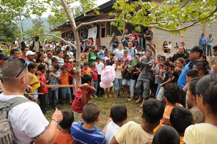 SAN JERONIMO, Honduras --  With help from local firemen and Joint Task Force-Bravo members, children in this remote village get to take a swing at a pinata here Oct. 16 during the Chapel Hike. More than 70 Team Bravo members hiked more than two miles to the village to deliver food and other goods. (U.S. Air Force photo/Tech. Sgt. Benjamin Rojek)