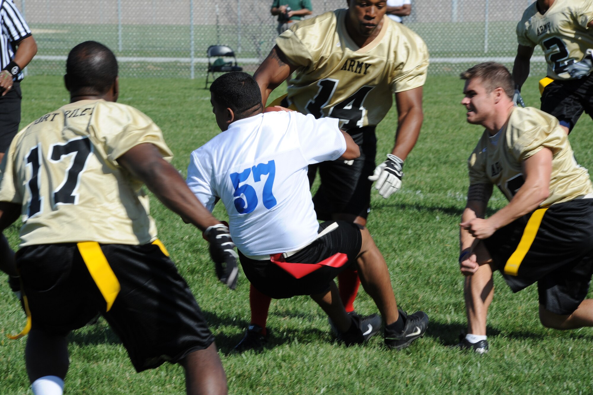 McConnell lineman Jose Rocco evades Fort Riley defenders gaining a first down Oct. 16, 2010, Fort Riley, Kan. Rocco was one of 22 Airmen from McConnell who clashed on the field with the Fort Riley’s flag football team. The Fort Riley team held off McConnell 13-6 with a touchdown in each half.  (U.S. Air Force photo/Airman 1st Class Armando A. Schwier-Morales)