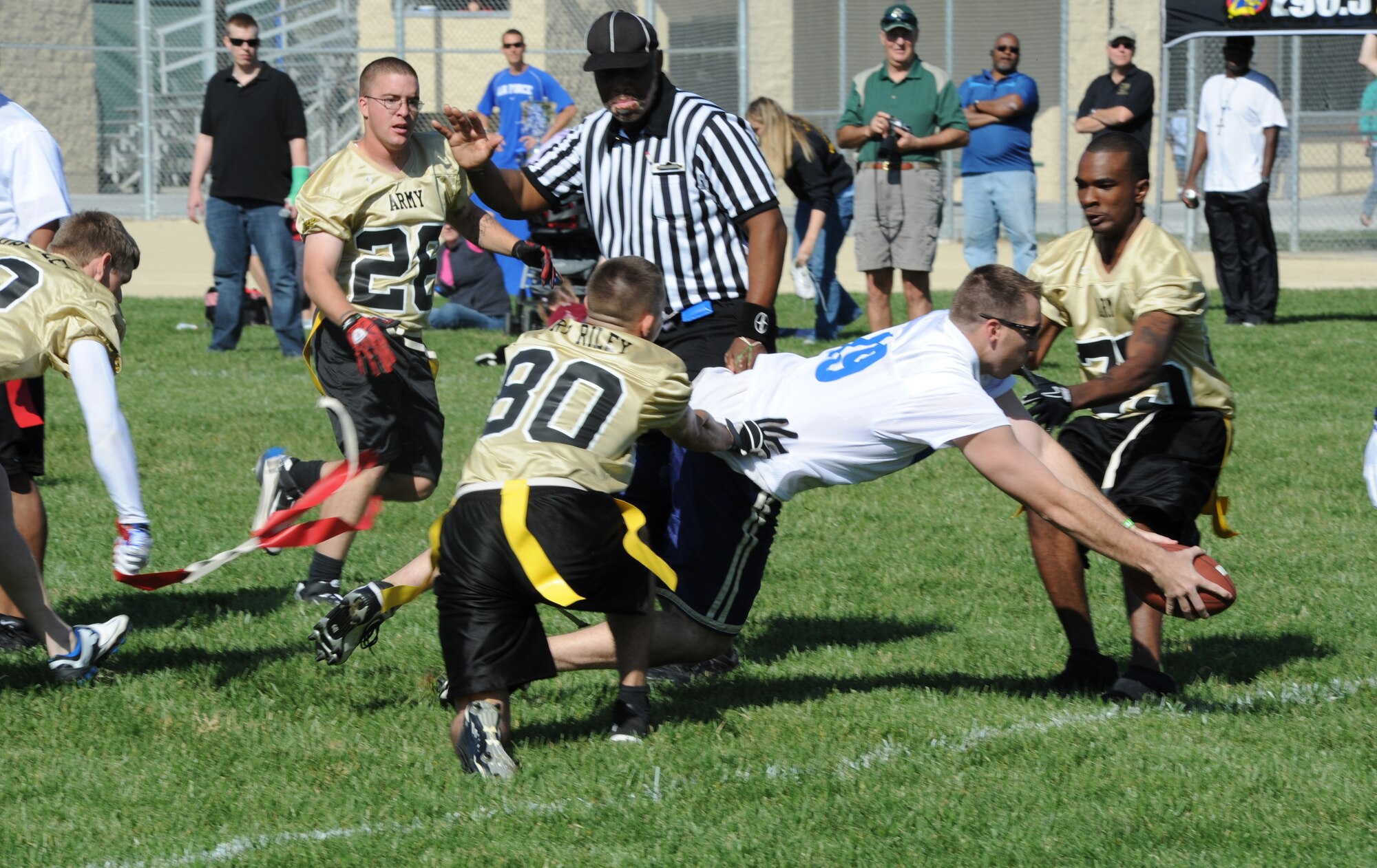 McConnell quarterback Chris Morgan dives for a first down Oct. 16, 2010, during a flag football game against Soldiers at Fort Riley, Kan. Fort Riley won the game 13-6-- their second win. The game was held to promote morale and spirit de corps. (U.S. Air Force photo/Airman 1st Class Armando A. Schwier-Morales)
