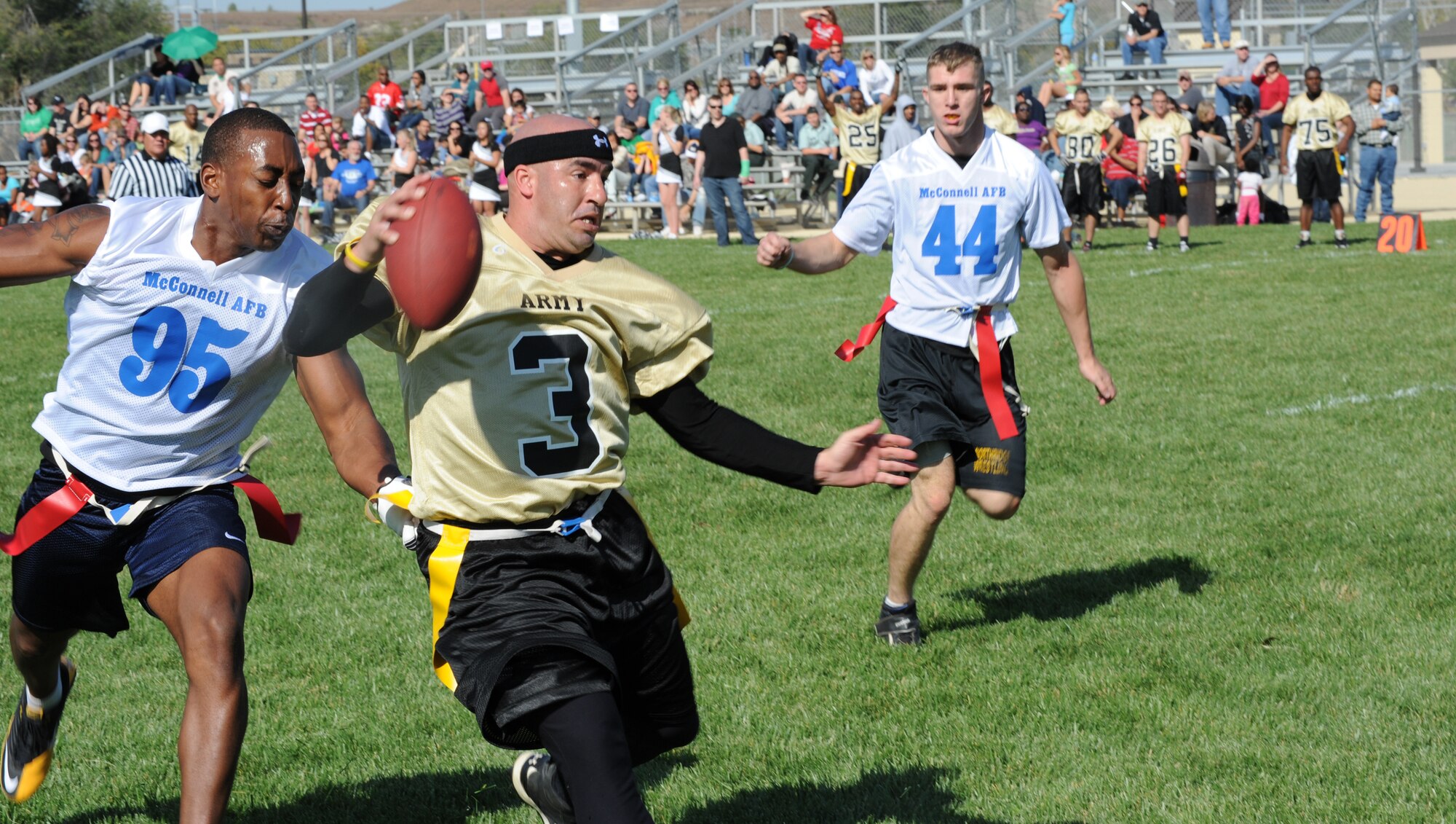 McConnell lineman Bronsha Smith stops Fort Riley quarterback Jason Lafasciano, and prevents a first down during a rematch flag football game between McConnell and Fort Riley. The Soldiers held of the Airmen earning a 13-6 victory.  The next game is scheduled to be played at McConnell 2011.  (U.S. Air Force photo/Airman 1st Class Armando A. Schwier-Morales)