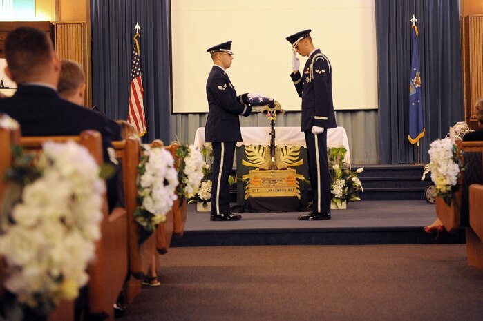 NELLIS AIR FORCE BASE, Nev.-- The Nellis Honor Guard performs a flag folding ceremony inside the base chapel during the memorial service for Senior Airman Michael Buras Oct. 15. Senior Airman Buras was an Explosive Ordnance Disposal Journeyman assigned to the 99th Civil Engineer Squadron. Airman Buras was killed in action while deployed to Afghanistan and responding to an Improvised Explosive Device Sept. 21. (U.S Air Force Photo / Senior Airman Stephanie Rubi)