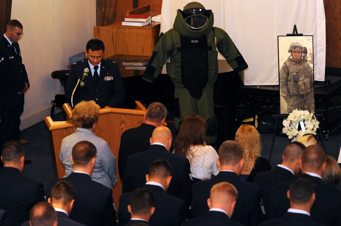 NELLIS AIR FORCE BASE, Nev.-- Capt. Andrew Suh, 99th Air Base Wing Chaplain, gives the invocation during Senior Airman Michael Buras' memorial service Oct. 15. Senior Airman Buras was an Explosive Ordnance Disposal Journeyman assigned to the 99th Civil Engineer Squadron. Airman Buras was killed in action while deployed to Afghanistan and responding to an Improvised Explosive Device Sept. 21. (U.S Air Force Photo / Senior Airman Stephanie Rubi)